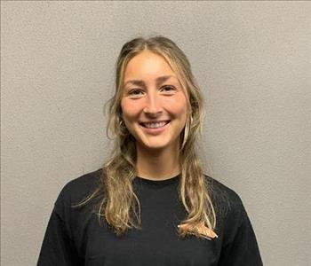 SERVPRO employee in front of beige background. 