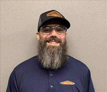 SERVPRO employee in front of beige background. 