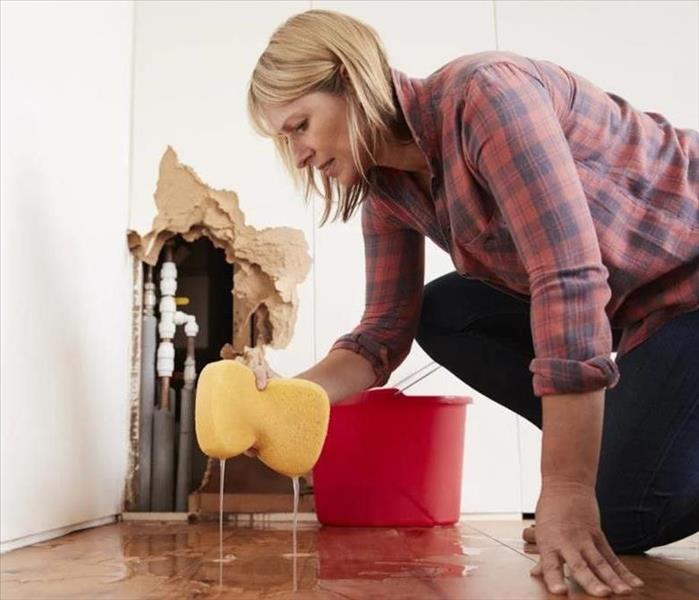 Serious Water Damage - image of woman cleaning water damage