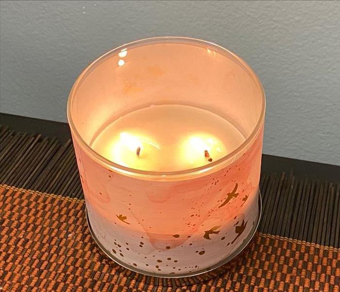 lit candle left on a dresser unattended